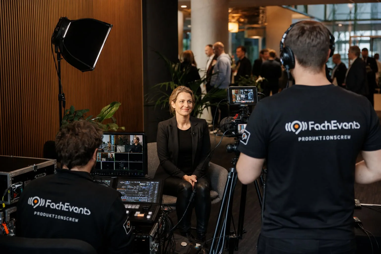 Interview für den Eventfilm: Eine Teilnehmerin vor Kamera und Licht in der Lounge einer Tagung